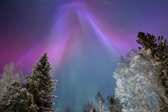 <p>The northern lights appear over Anchorage, Alaska, on Wednesday. The Space Weather Prediction Center says a minor geomagnetic storm is likely to impact Earth over the weekend, bringing the potential for more dazzling skies </p>