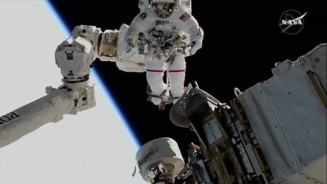 <p>NASA spacewalker Suni Williams is attached to the tip of the Canadarm2 robotic arm as the International Space Station orbits 260 miles above the Earth on Thursday. Williams just broke the record for total spacewalk time by a woman</p>