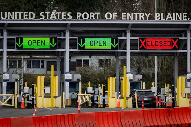 <p>A car waits at the United States and Canada border</p>
