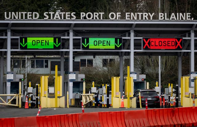 <p>A car waits at the United States and Canada border</p>