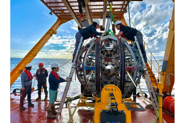 <p>Scientists prepare to lower equipment used to detect neutrinos into the Mediterranean Sea. (Paschal Coyle, KM3NeT via AP)</p>