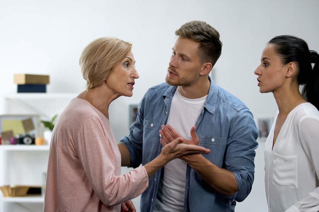 <p>Young man settling conflict between mother and wife</p>