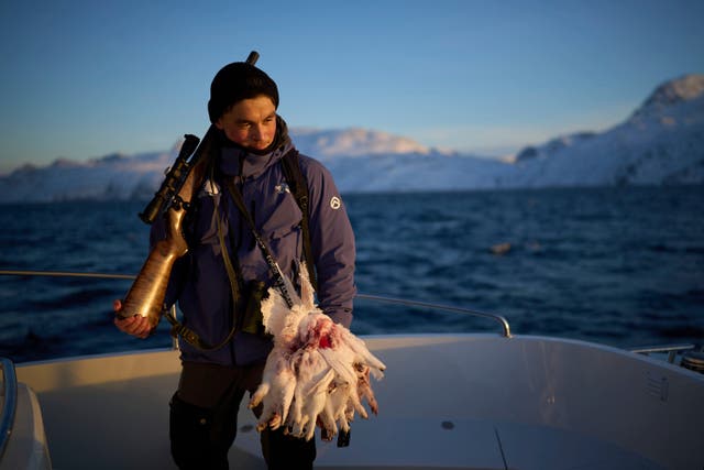 <p>Bilo Chemnitz, 23, holds his rifle after hunting ptarmigan birds near the Nuuk fjord in Greenland, Monday, Feb. 17, 2025. (AP Photo/Emilio Morenatti)</p>