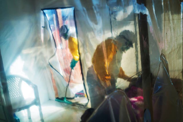 <p>Health workers wearing protective suits tend to to an Ebola victim kept in an isolation tent in Beni, Democratic Republic of Congo, on Saturday, July 13, 2019</p>